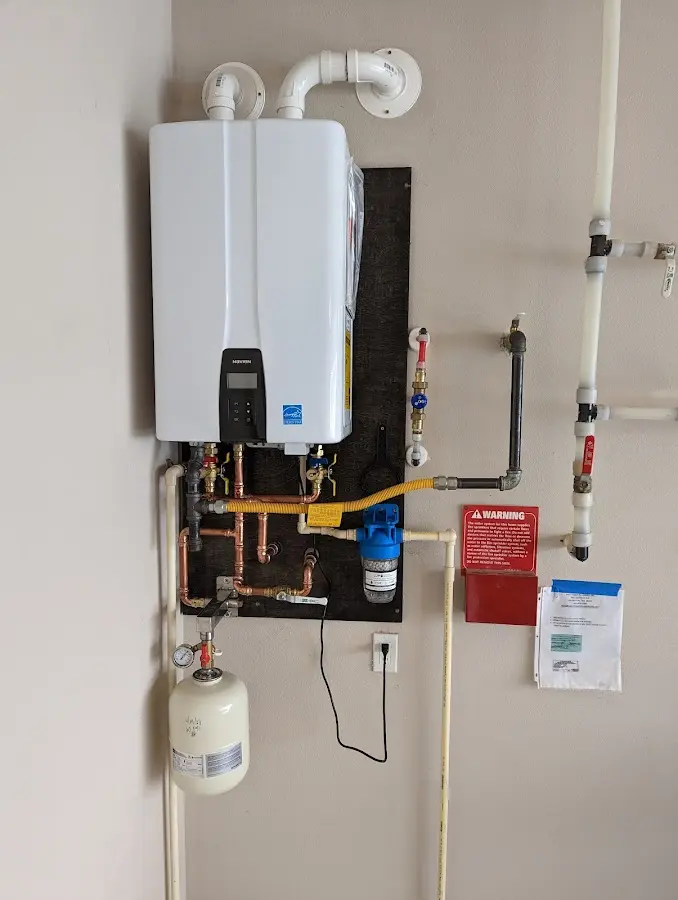 Professional plumber installing copper piping in a Decatur home